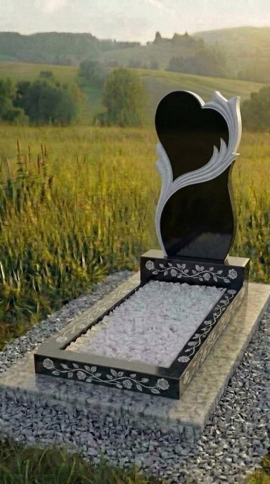 Гранитный памятник в форме сердца из чёрного карельского гранита габбро с резным декоративным элементом