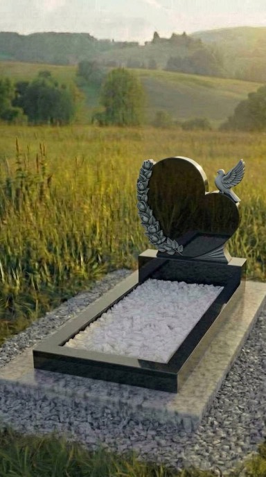 Двойной памятник на могилу из чёрного гранита с голубкой и резным цветочным оформлением